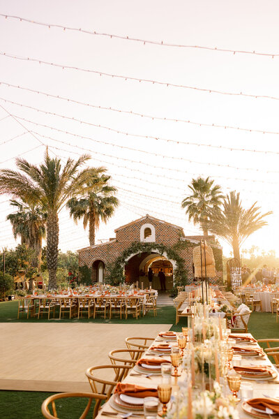 A beautiful sunset cascades over a tropical wedding reception space in Los Cabos Mexico