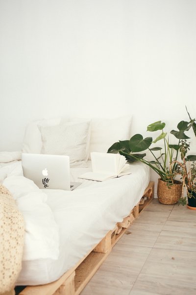 White pallet bed with silver macbook