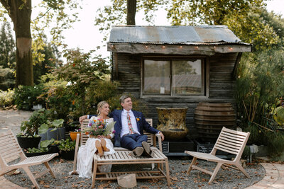 bride and groom relaxing in outdoor garden center