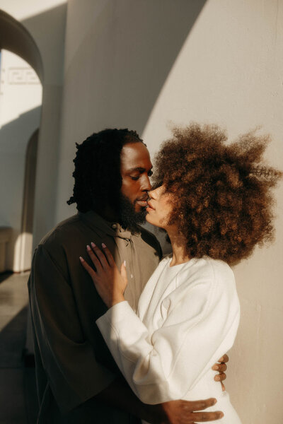 Modern couple embracing in golden sunlight during a romantic engagement session with a Washington state photographer.