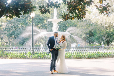 A tender, romantic moment shared between the bride and groom during their Forsyth Park elopement in Savannah.