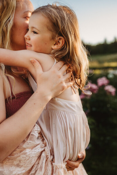 Two young girls hugging and laughing at Country Cut Flowers in Newmarket at sunset