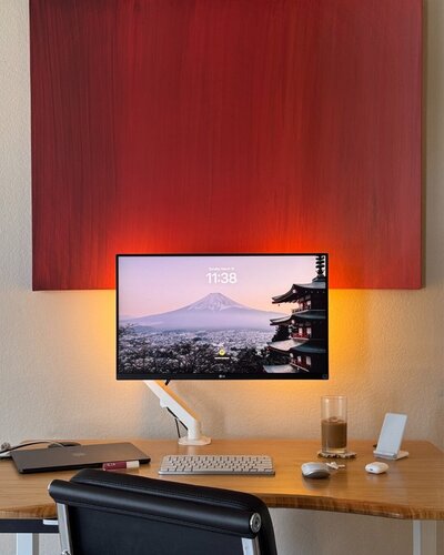 aesthetic desk setup with a red painting in the background of an influencer virtual assistant