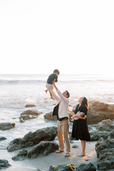 Candid family portrait of family playing at El Matador Beach at golden hour
