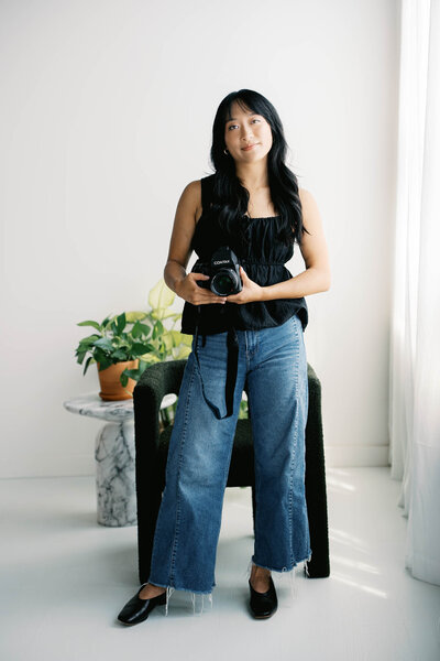 rachael shek holds contax 645 by window in a studio taken by boston documentary wedding photographer