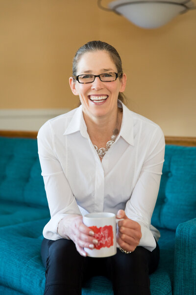 picture of woman smiling and holding a mug