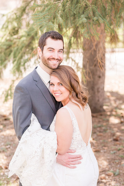 Bride and Groom sharing their first kiss during outdoor wedding