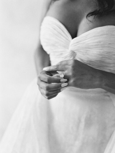 black and white photography - bride with her hands folded and touching her ring