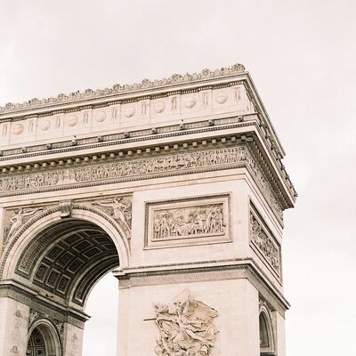 architectural arch in France with white sky behind