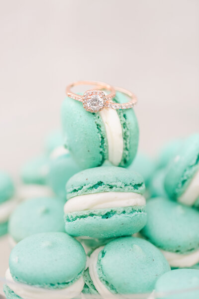 engagement ring and wedding band  sitting on macaroons