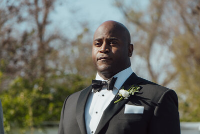 African American groom waits for his bride.