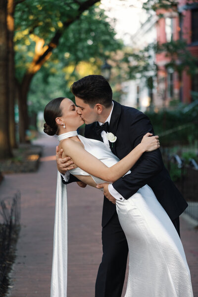 Bride and groom share a mid aisle kiss after becoming husband and wife. Photo by Northern Virginia Wedding Photographer.
