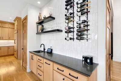 a stone fireplace wall with tv mount and wood beams