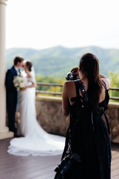 montana wedding photographer taking a picture of a bride and groom kissing with mountains in the background