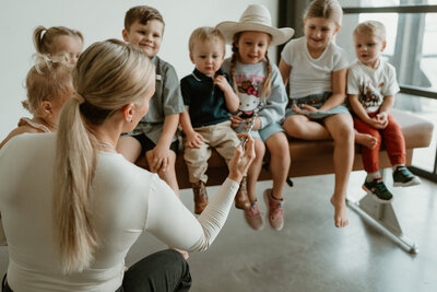 group of children learning about chiropractic tools