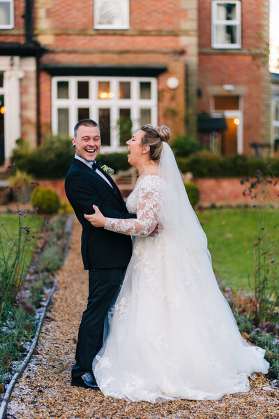 A newly wed couple laughing outside Ashfiled House captured by Anthony Horseman Photography and Film