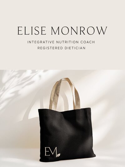 Branded tote bag mockup featuring the Elise Monrow EM monogram with a leaf accent, styled in natural light with soft shadows—representing the approachable, elevated feel of the wellness brand.

