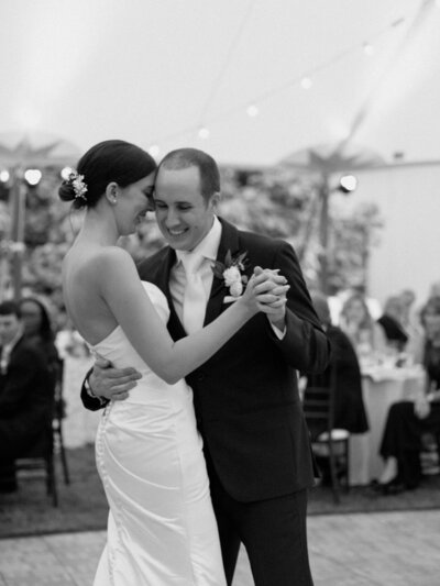 Couple sharing their first dance under a tent