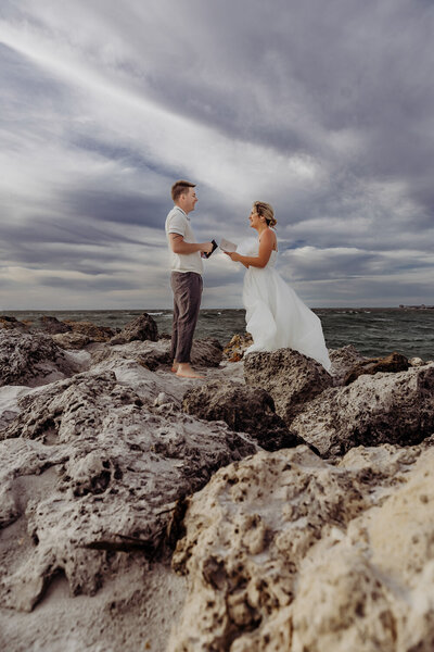 Couple reading vows at their florida beach elopement