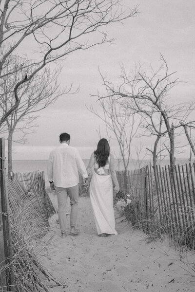 A couple walking away to the beach in Maryland