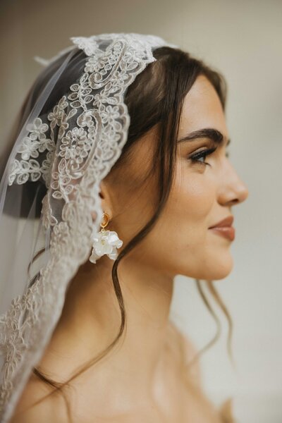 bride putting in earrings