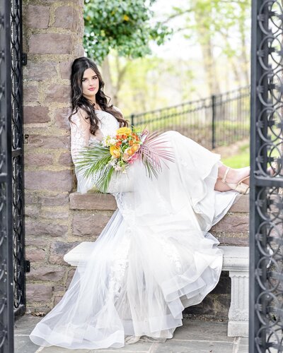 Bride sitting on ledge