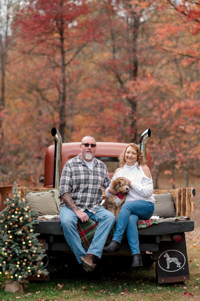 Smiling family sitting on truck bed during Christmas mini session near York, PA
