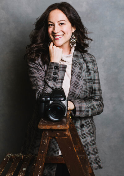 woman smiling holding camera