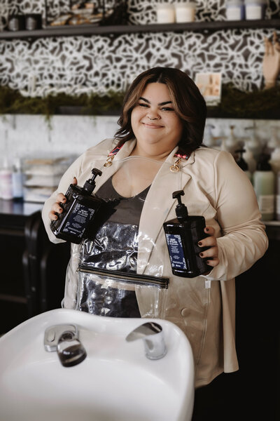 Haven poses with shampoo and conditioner to promote her brand.