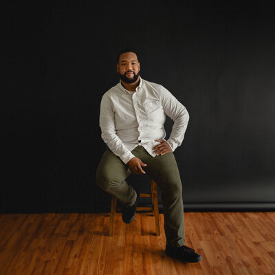 Quinton sitting on stool