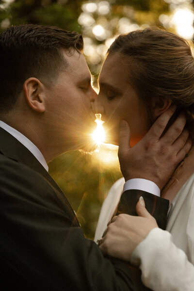 Wedding Couple Kisses with Sun Flare