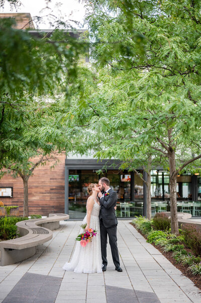 Bride and groom kissing in front of District Winery
