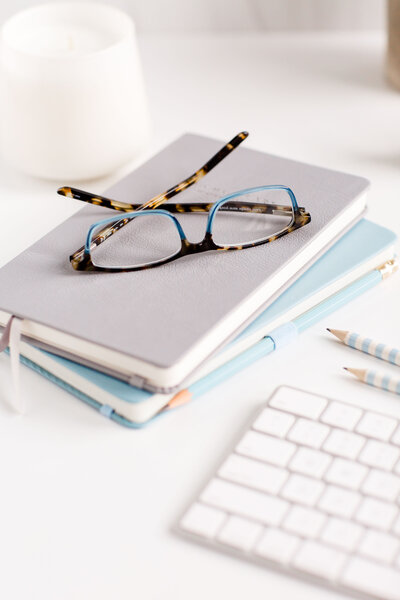 stock image of glasses on a notebook by social curator