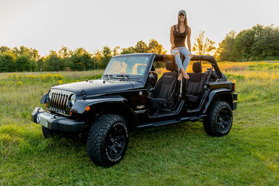 Girl sitting ontop of Jeep