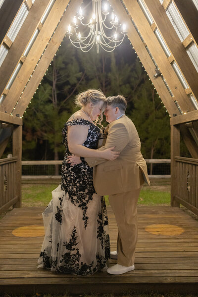 bride and bride hugging at sunset by Amanda Richardson Photography