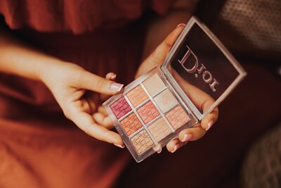 Caitlin holding a Dior makeup palette