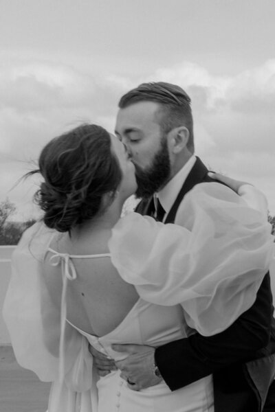 bride & groom joyfully smiling at the camera