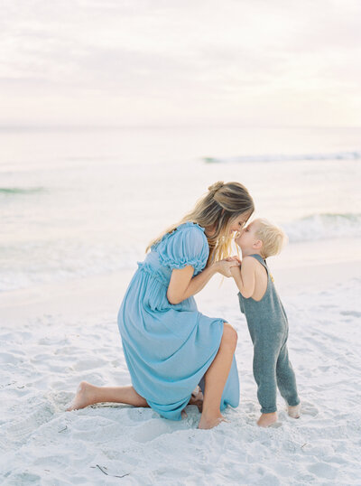 expecting mother with toddler at beach by Orlando lifestyle photographer