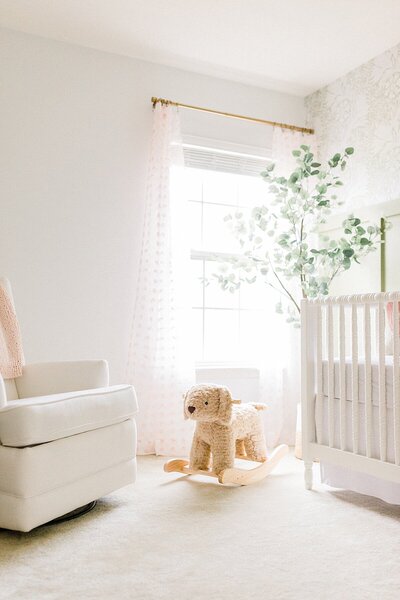 A pink and white baby girl nursery by newborn photographer, Katelyn Ng Photography.
