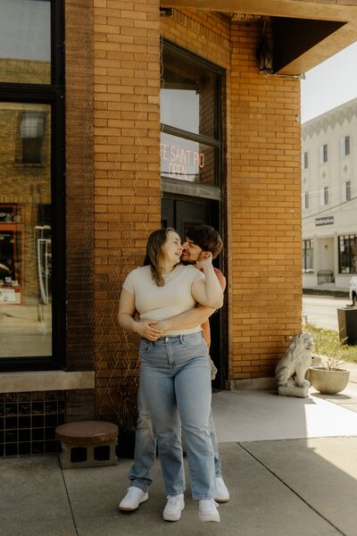 A couple laughs together outside a coffee shop in CedarRapids, Iowa.
