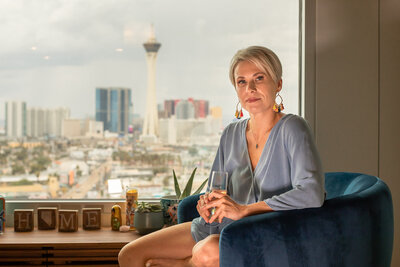 woman poses in front of downtown las vegas for brand photos