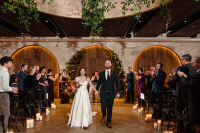 Bride and groom get married surrounded by fall flowers and candles at Chicago WInery