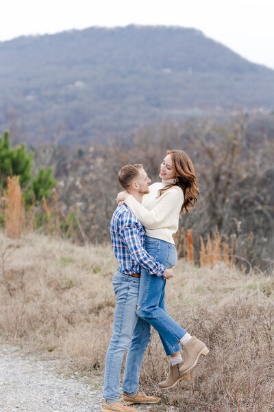 couple posing on the Chestnut Street Trailhead for engagement pictures in the fall