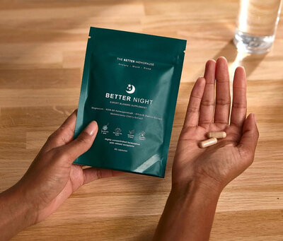 Hand holding Better Night supplement by The Better Menopause, a sleep support formula with magnesium, ashwagandha and saffron for perimenopause.