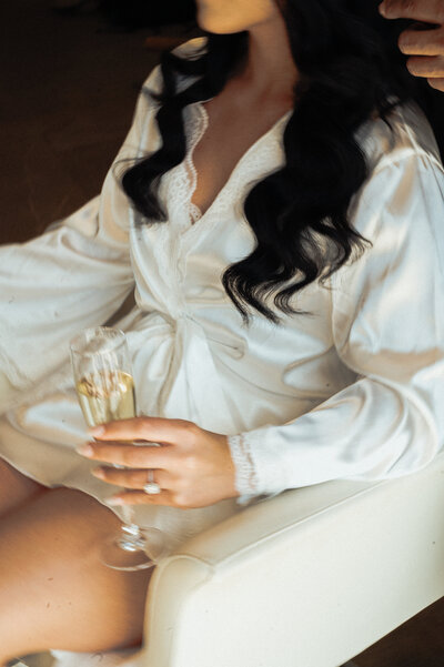 Bridal portrait in Puerto Vallarta Mexico at Dreams Bahia Mita resort destination wedding getting ready photos with engagement ring and glass of champagne