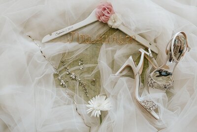 Bridal details including jewelry, veil, and shoes