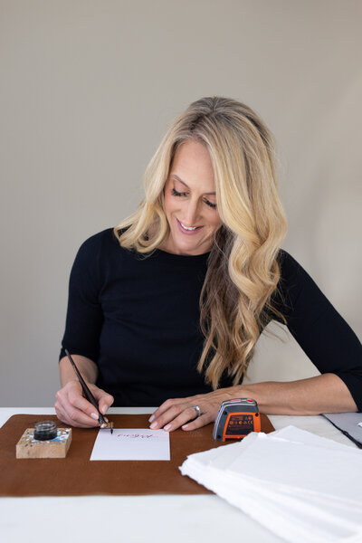 Connecticut calligrapher doing calligraphy at her desk