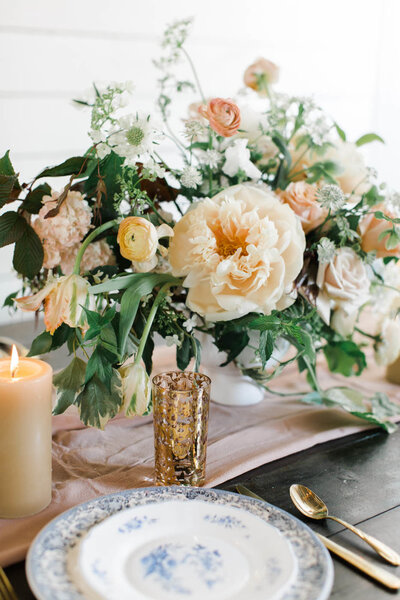White and peach floral centerpiece designed by san diego wedding florist