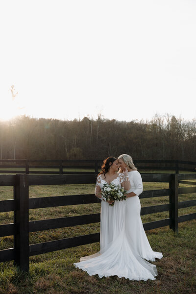 Bridal portraits of 2 brides sharing an intimate moment 