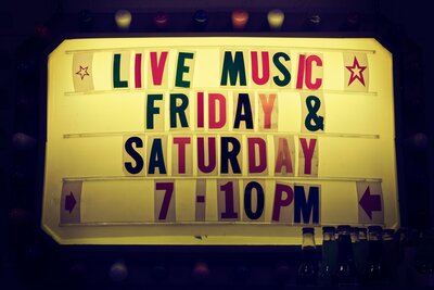 sign outside of a bar spelling out Live Music Friday & Saturday 7pm
